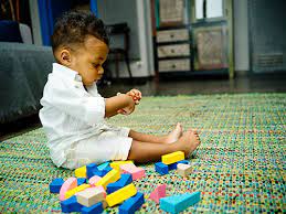 child playing with blocks on the floor